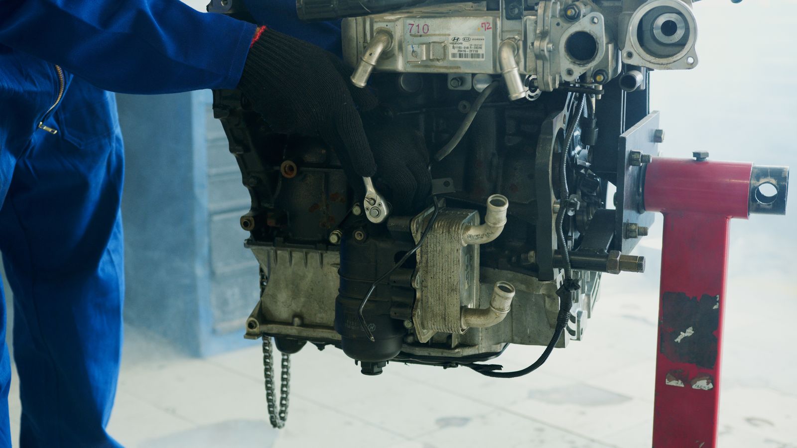 Technician's hands on an engine